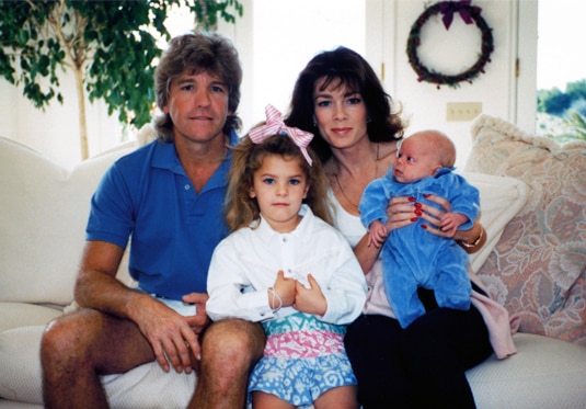 Lisa Vanderpump sitting with Ken Todd and their two children on a couch.