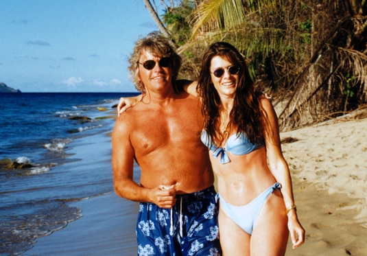 Lisa Vanderpump posing with Ken Todd in a bikini at the beach.