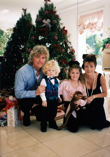 Lisa Vanderpump posing with Ken Todd and her two kids, Pandora Vanderpump-Todd and Max Vanderpump-Todd, in front of a Christmas tree.