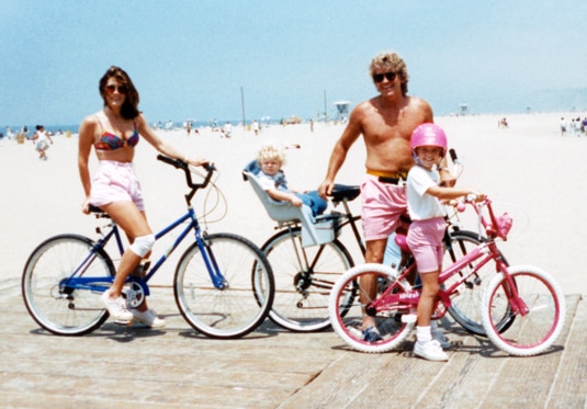 Lisa Vanderpump and her family riding bikes on the beach.