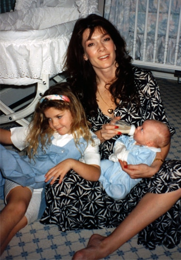 Lisa Vanderpump sitting on the floor with Pandora and feeding her baby, Max.