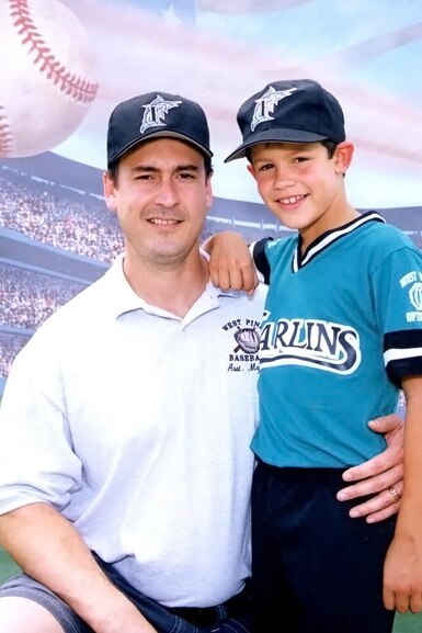 Peter Rosello seeen with his father wearing a Marlins baseball uniform.