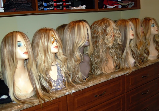A group of Kim Zolciak's blonde wigs on mannequins