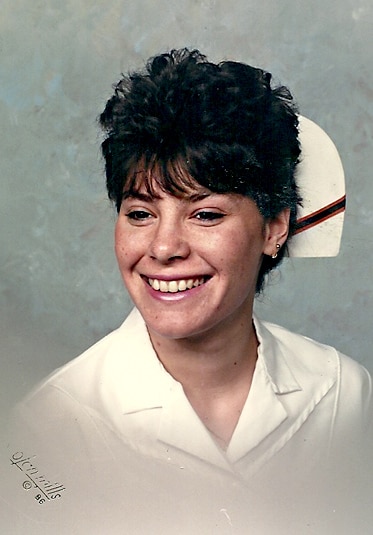 Luann de Lesseps smiling as a young woman wearing a nursing uniform.