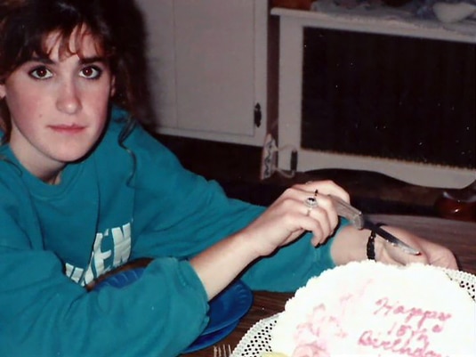 A young Kim Zolciak of the Real Housewives of Atlanta cutting a cake