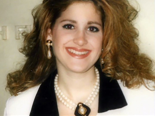 Kim Zolciak of RHOA smiling as a young woman