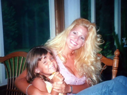 A young Kim Zolciak smiling with her daughter