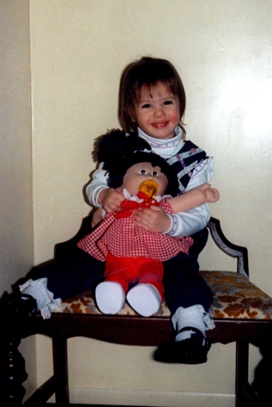 Kristen Doute plays with a cabbage patch doll as a young girl.