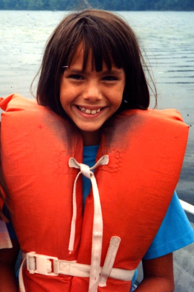 Kristen Doute wears a life jacket at a lake.