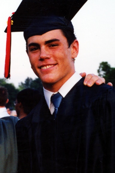 Tom Sandoval wears a graduation cap and gown at his high school graduation.