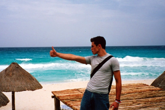 Tom Sandoval posing on a beach.