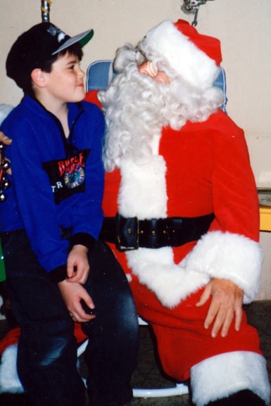 Tom Sandoval sits on Santa's lap as a young child.