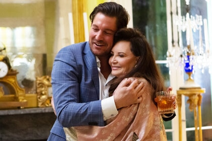 Craig Conover hugging Patricia Altschul and smiling together.
