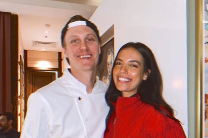 Danielle Olivera and Robert Sieber together while Robert is in his chef's uniform.
