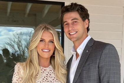 Southern Charm's Madison LeCroy smiles on a porch with her husband Brett Randle.