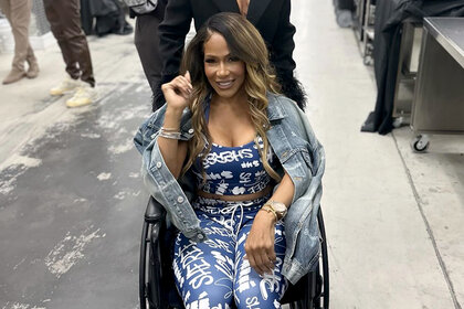 Sheree Whitfield gets pushed in a wheelchair while backstage at Bravocon 2023.