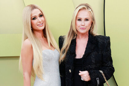 Paris Hilton and Kathy Hilton pose together on a red carpet