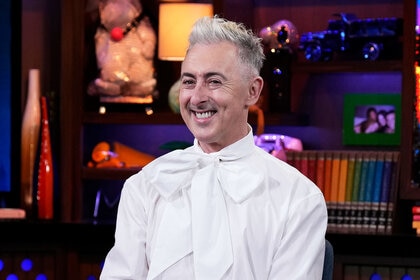 Alan Cumming smiling at the Watch What Happens Live clubhouse in New York City.