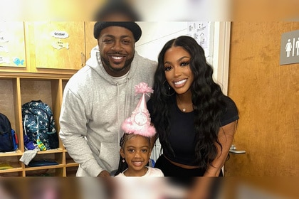 Porsha Williams and Dennis Mckinley posing and smiling with Pilar Jhena.