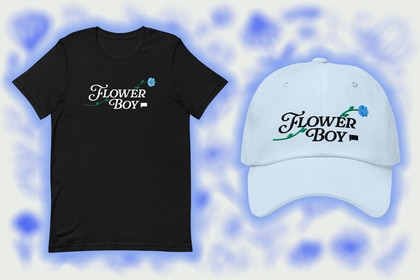 A black tee shirt and white baseball cap that say Flower Boy on them.