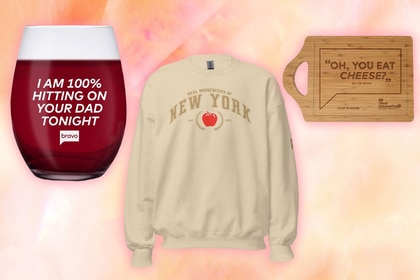 A wine cup, a sweatshirt and a cheese board on a multi-colored peach background.