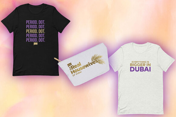 A black tee, a white pouch, and a white tee part of The Real Housewives of Dubai Merchandise.