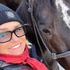 Yolanda Hadid smiling next to a horse.