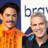 Andy Cohen and Tom Sandoval smiling together in front of a step and repeat at BravoCon 2022.