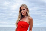 Tracy in red dress by the ocean.
