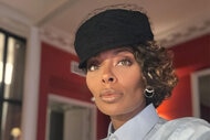 Eva Marcille in a black hat with a netted detail.