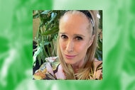Kim Richards takes a selfie wearing a black headband in front of a plant.