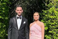 Lindsay Hubbard and Carl Radke dressed in formal wear standing in front of foliage.