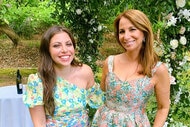 Jill and Ally smile together in floral print dresses outdoors.