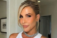 Tracy in an updo wearing a white tank top and silver chain necklace.
