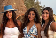 Teresa Giudice, Milania Giudice, and Audriana Giudice pose together at Scorpios, Mykonos on the sand in front of a sculpture.