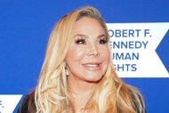 Adrienne Maloof smiling in front of a blue step and repeat.