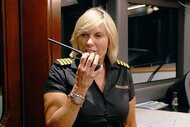 Captain Sandy Yawn in uniform speaking into her walkie talkie.