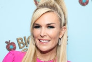 Tinsley Mortimer posing in a pink outfit in front of a step and repeat.