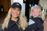 Gretcheen Rossi holds her daughter and they both smile together.