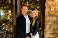 Alexis Bellino and John Janssen standing next to each other and holding hands.