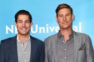 Craig Conover and Austen Kroll smile in front of a blue NBCUniversal backdrop.