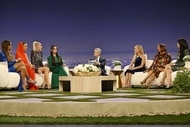 The cast of The Real Housewives of Beverly Hills listen to Andy Cohen in front of a Beverly Hills themed set during the Season 13 Reunion.