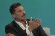 Jax Taylor speaks in front of a teal background.