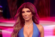 Teresa Giudice wearing a blue gown in front of a carnival backdrop.