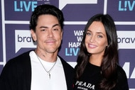 Tom Sandoval and Victoria Lee Robinson pose in front of a step and repeat at the Watch What Happens Live clubhouse in New York City.