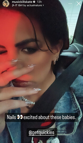Katie shows her nails and makeup while in a car.
