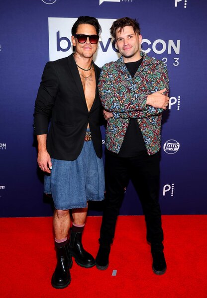 Tom Sandoval and Tom Schwartz posing together while walking the red carpet for BravoCon 2023.