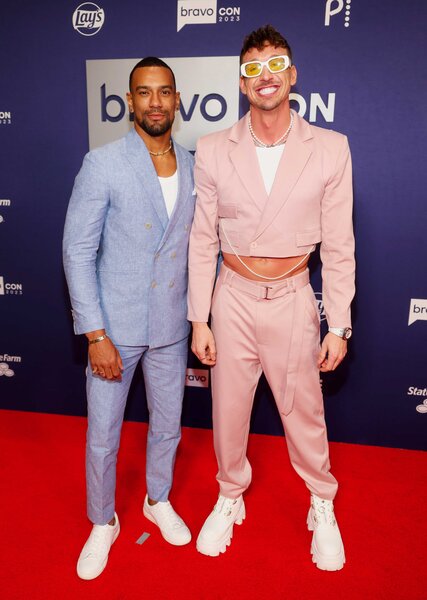 Jason Cameron and Kory Keefer posing together while walking the red carpet for BravoCon 2023.