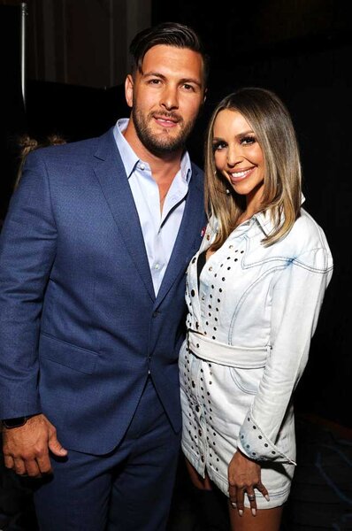 Brock Davies and Scheana Shay smiling and posing together during BravoCon 2023.