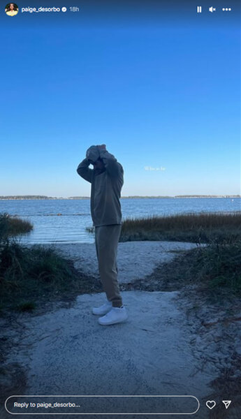 Craig Conover of Southern Charm adjusts his hat on a beach on Paige DeSorbo's Instagram.